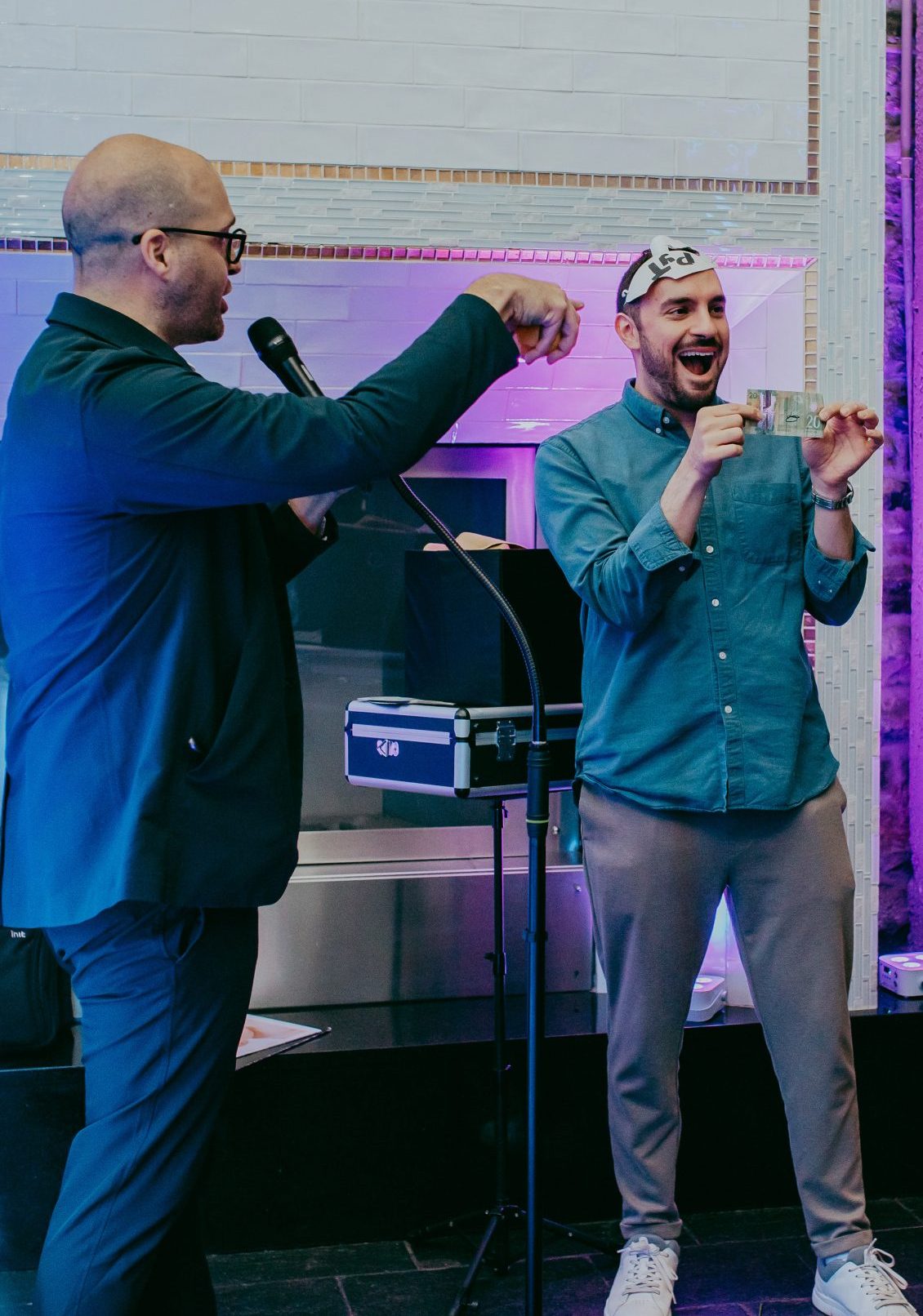 Michael Bourada performing magic at a corporate event